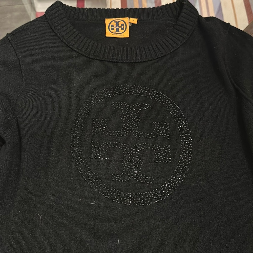 Black Tory Burch sweater with crystal logo on front
